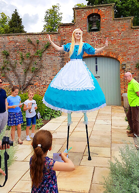 uk alice in wonderland stilt walkers